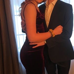 A short tight maroon dress with open back